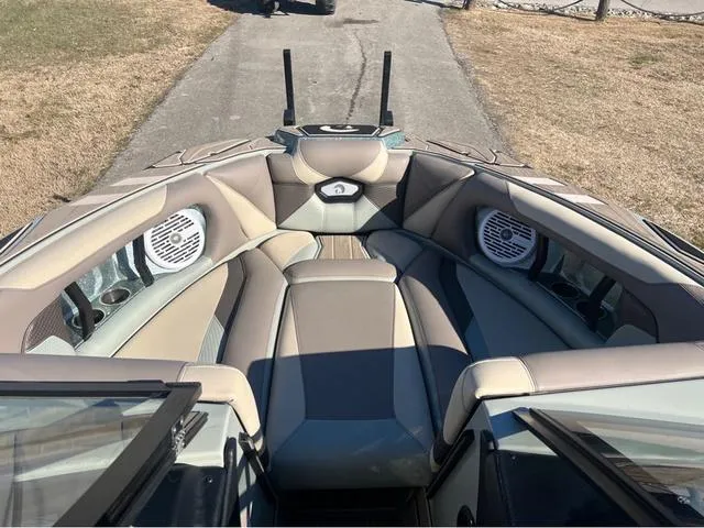 Slide: The Image of 2022 Centurion Ri230 boat interior with cushioned seating and built-in speakers. - 10