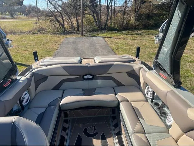 Slide: The Image of 2022 Centurion Ri230 boat interior with plush seating and premium audio system. - 12