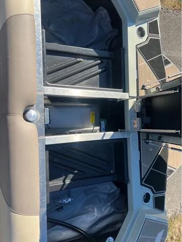 Slide: The Image of 2022 Centurion Ri230 boat storage compartments with open lids, showcasing interior design. - 13