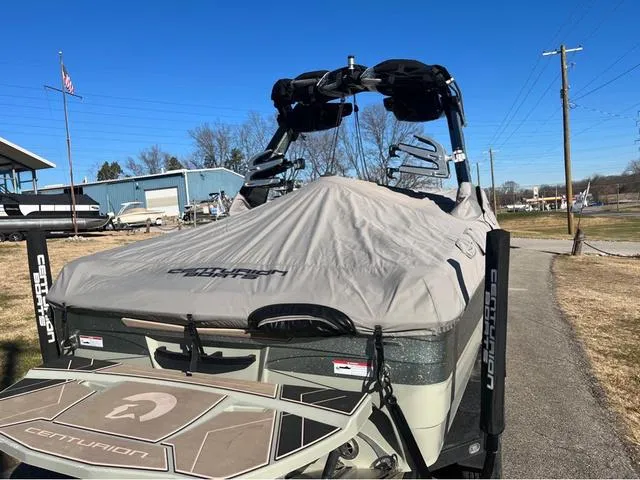 Slide: The Image of 2022 Centurion Ri230 boat with cover in a marina. - 15