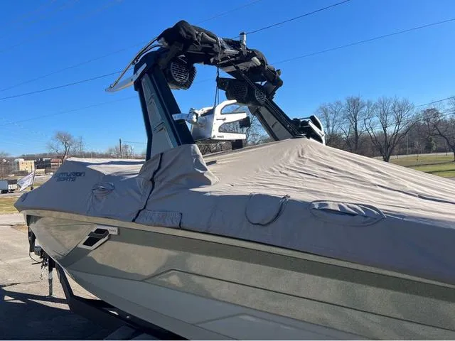 Slide: The Image of 2022 Centurion Ri230 boat with cover, parked outdoors on a sunny day. - 16
