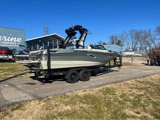 Slide: The Image of 2022 Centurion Ri230 boat on a trailer outside a marine service center. - 3