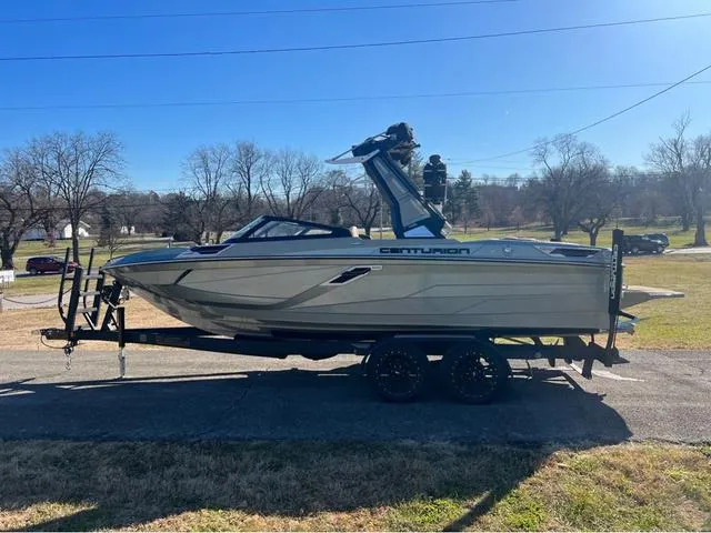 Slide: The Image of 2022 Centurion Ri230 boat on a trailer in a sunny outdoor setting. - 6