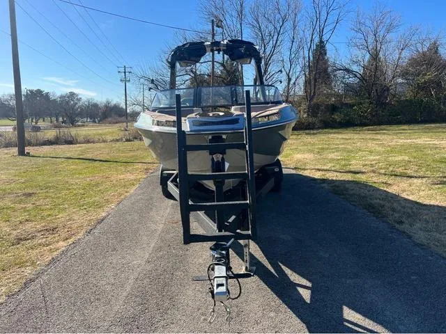 Slide: The Image of 2022 Centurion Ri230 boat on trailer in a driveway. - 7