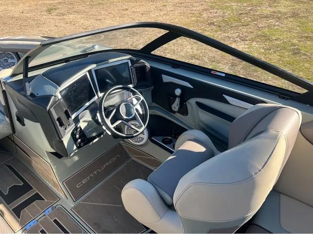 Slide: The Image of 2022 Centurion Ri230 boat cockpit with modern dashboard and steering wheel. - 9