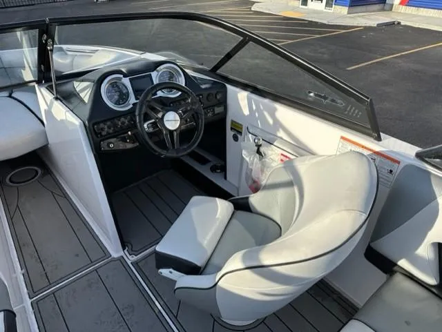 Slide: The Image of 2018 Moomba Mojo boat interior with steering wheel and dashboard controls. - 11