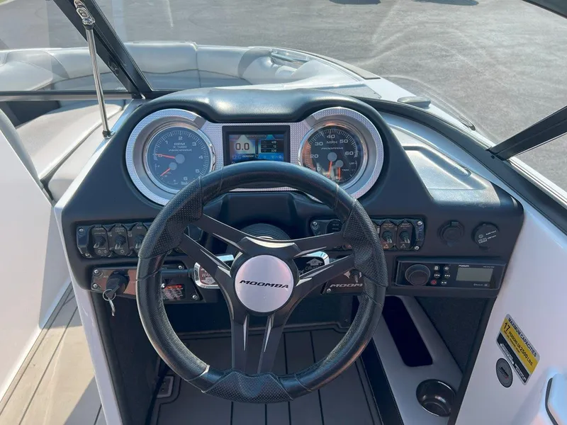 Slide: The Image of 2018 Moomba Mojo boat dashboard with steering wheel and gauges. - 12