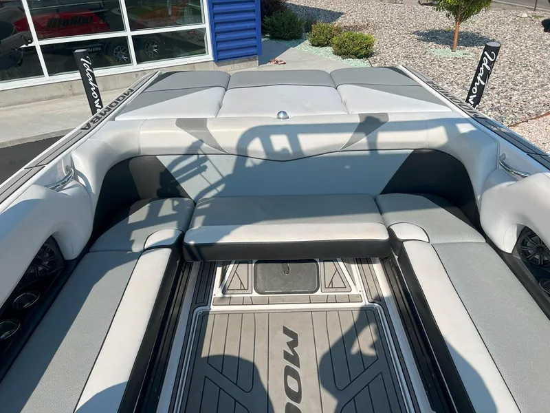 Slide: The Image of 2018 Moomba Mojo boat interior with gray seating and flooring. - 14