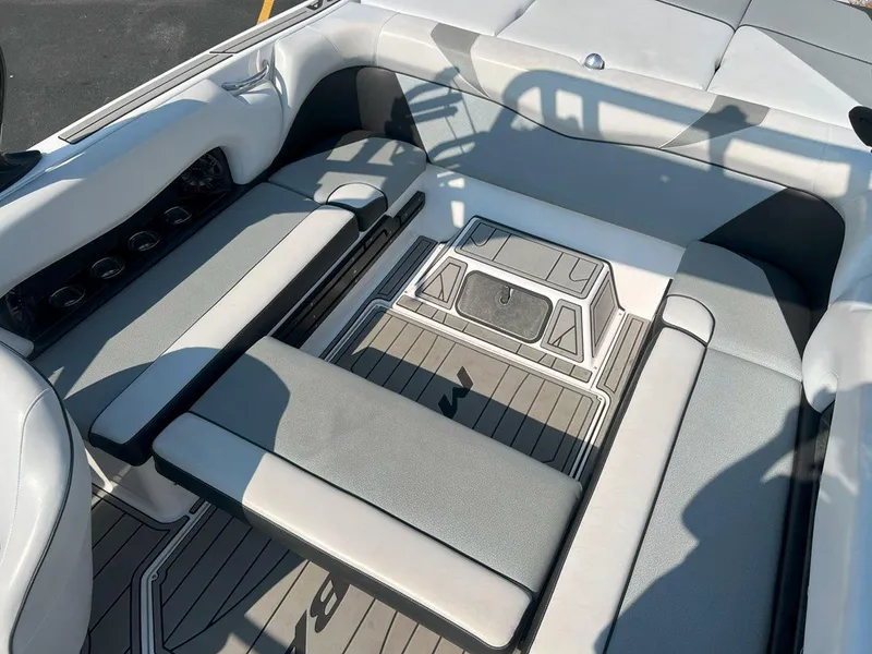 Slide: The Image of 2018 Moomba Mojo boat interior with gray seating and deck. - 15