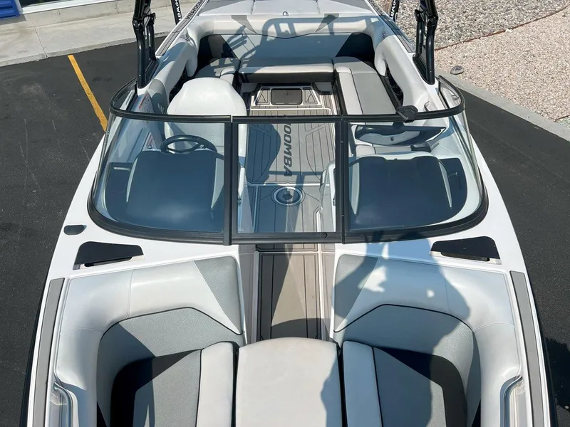 Slide: The Image of 2018 Moomba Mojo boat interior with seating and steering wheel, viewed from above. - 16