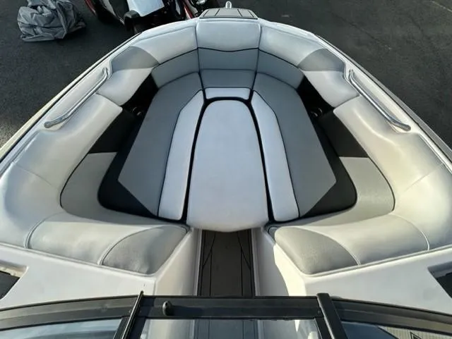 Slide: The Image of 2018 Moomba Mojo boat interior with gray seating and sleek design. - 18