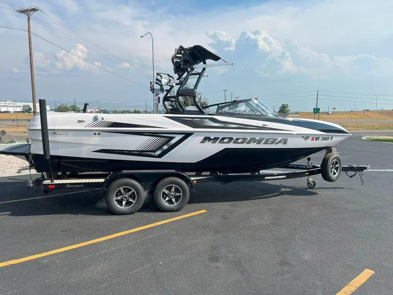 Slide: The Image of 2018 Moomba Mojo boat on trailer in parking lot, clear sky background. - 7