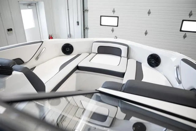 Slide: The Image of The image shows the modern, cushioned interior of a 2024 Yamaha 195S boat. - 16