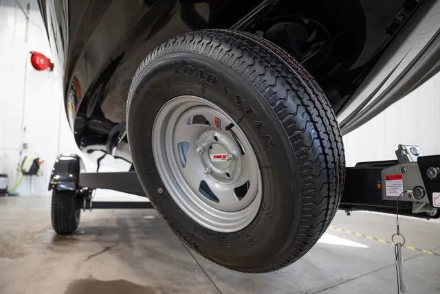 Slide: The Image of Close-up of a boat trailer with a sturdy tire in a garage. - 24