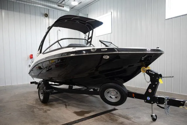 The Image of A 2024 Yamaha 195S boat on a trailer inside a warehouse. - 1