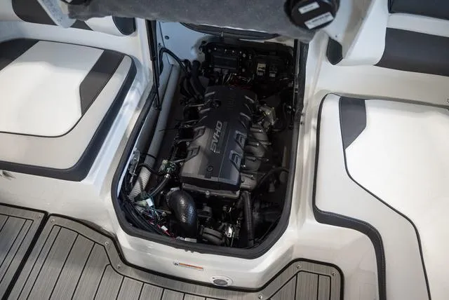 Slide: The Image of The engine compartment of a 2024 Yamaha Boats 195S with a neatly installed engine and wiring. - 19