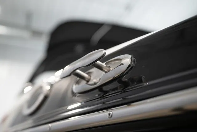 Slide: The Image of Close-up of a shiny metal fitting on a 2024 Yamaha 195S boat. - 21