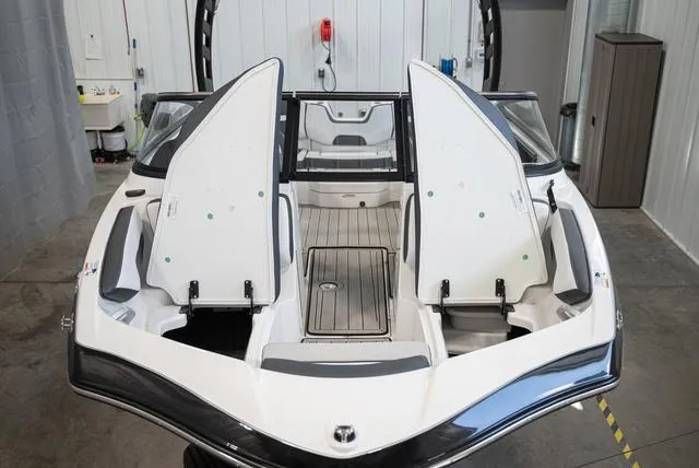 Slide: The Image of The image shows the open deck of a 2024 Yamaha 195S boat in a warehouse. - 18