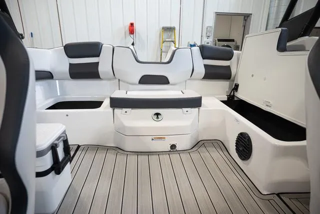 Slide: The Image of Interior of a 2024 Yamaha Boats 195S with gray and white seating and wood flooring. - 15