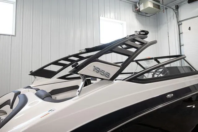 Slide: The Image of A 2024 Yamaha 195S boat in a warehouse. It features a sleek design with black accents. - 22