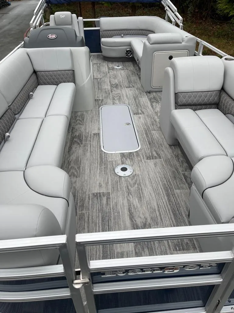 Slide: The Image of 2024 Ranger Reata 223C pontoon boat with spacious seating and modern interior design. - 4