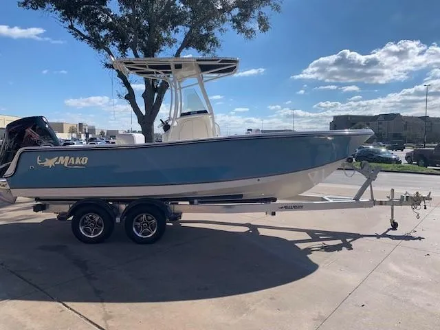 The Image of 2024 Mako 214 CC boat on a trailer in a parking lot. - 0