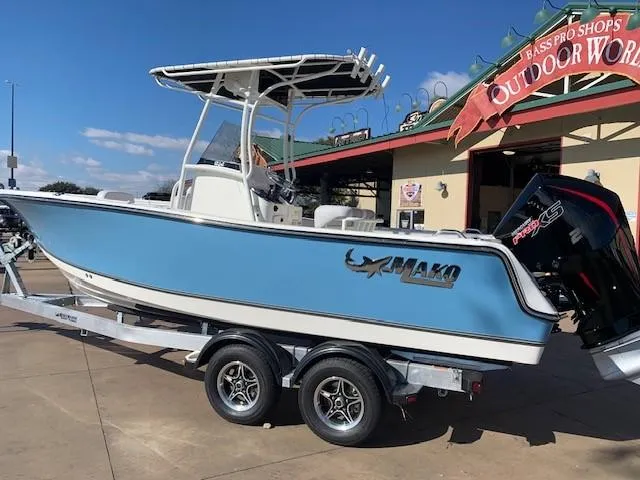 Slide: The Image of 2024 Mako 214 CC boat on trailer outside Bass Pro Shops Outdoor World. - 1