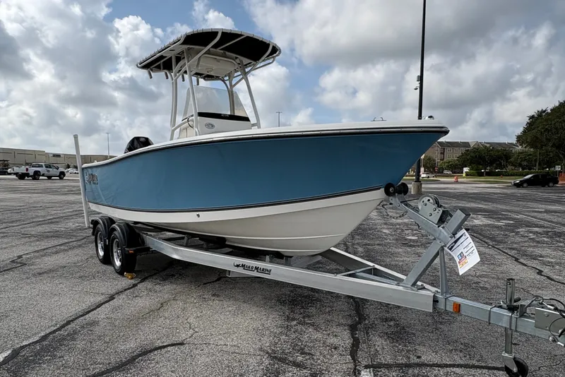 Slide: The Image of A 2024 Mako 214 Center Console boat on a trailer in a parking lot. - 11