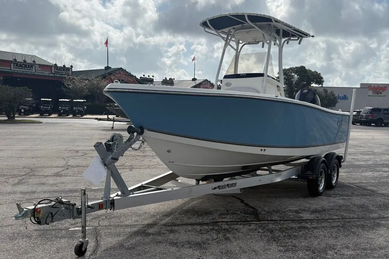 The Image of A 2024 Mako 214 Center Console boat on a trailer in a parking lot. - 0
