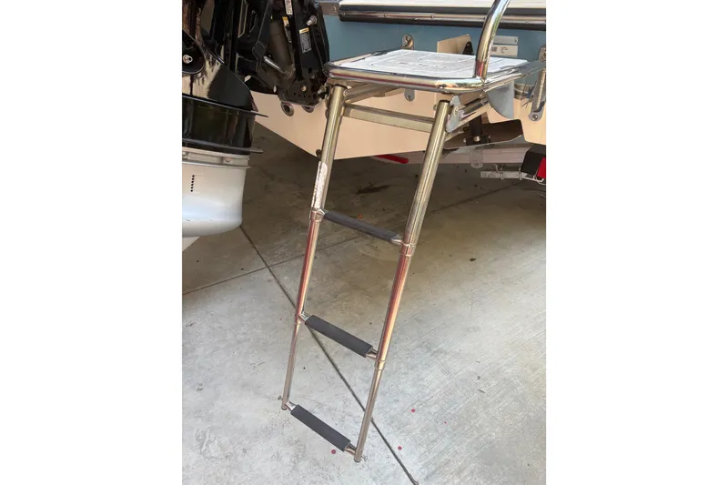 Slide: The Image of Stainless steel ladder on 2024 Mako 214 Center Console boat, docked on concrete. - 15