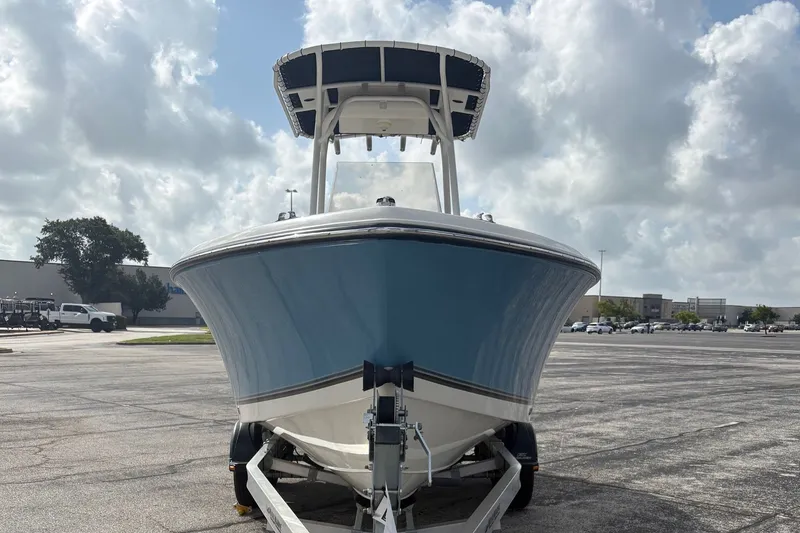 Slide: The Image of A 2024 Mako 214 Center Console boat on a trailer in a parking lot. - 1