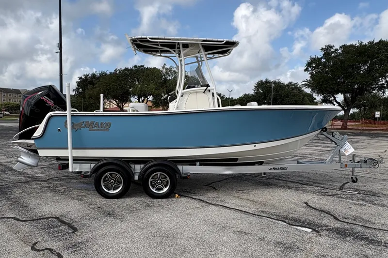 Slide: The Image of A 2024 Mako 214 Center Console boat on a trailer in a parking lot. - 10