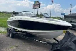 The Image of 2024 Tahoe 210 Si boat on a trailer in a parking lot. - 0