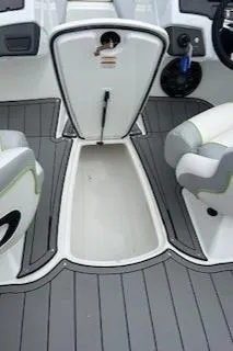 Slide: The Image of 2024 Tahoe 210 Si boat interior with storage compartment and seating. - 10