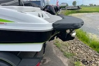 Slide: The Image of 2024 Tahoe 210 Si boat rear view by a lakeside. - 2