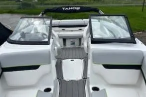 Slide: The Image of 2024 Tahoe 210 Si boat interior with dual windshields and seating. - 5