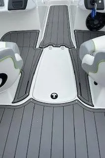 Slide: The Image of 2024 Tahoe 210 Si boat interior with gray flooring and white seats. - 9