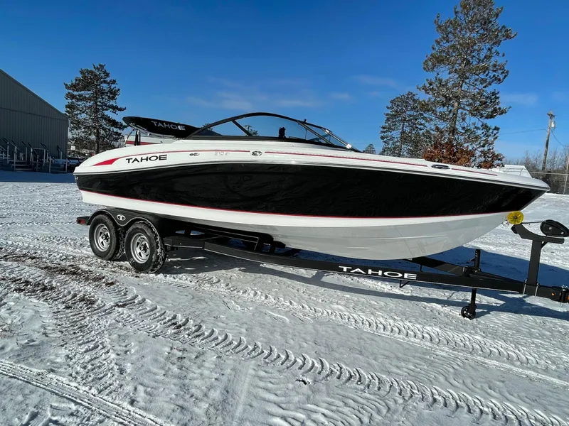 The Image of 2024 Tahoe 210 Si boat on trailer in snowy landscape. - 0