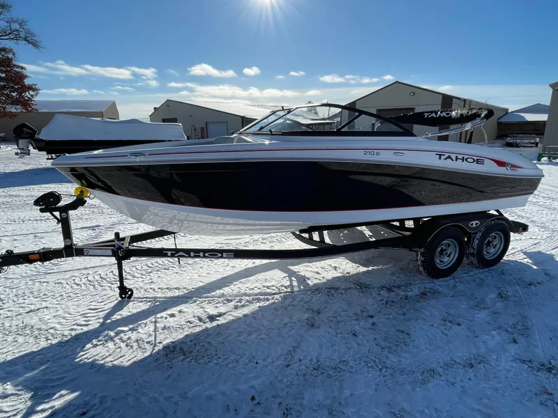 Slide: The Image of 2024 Tahoe 210 Si boat on trailer in snowy outdoor setting. - 1