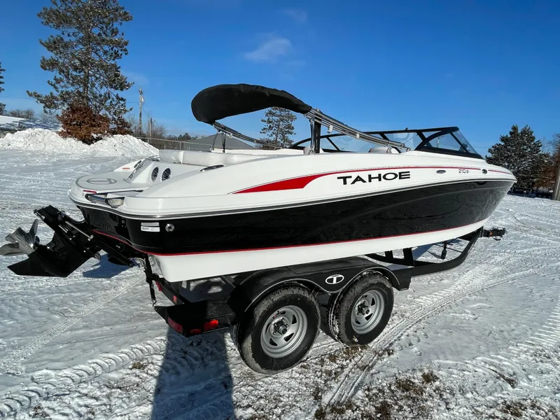 Slide: The Image of 2024 Tahoe 210 Si boat on trailer in snowy landscape. - 4