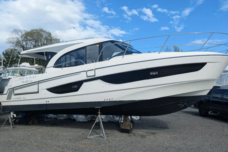 The Image of 2024 Beneteau Antares 11 boat on display, white hull, outdoor setting, blue sky background. - 0