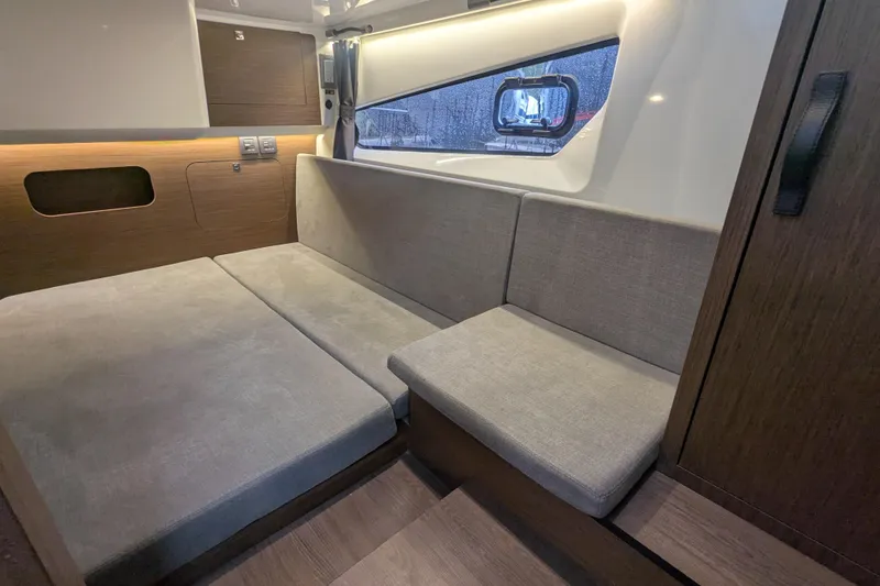 Slide: The Image of 2024 Beneteau Antares 11 interior with modern seating and wood accents. - 12