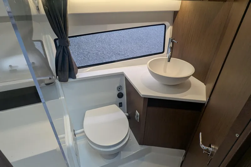 Slide: The Image of Modern bathroom in 2024 Beneteau Antares 11 yacht with toilet and stylish sink. - 14