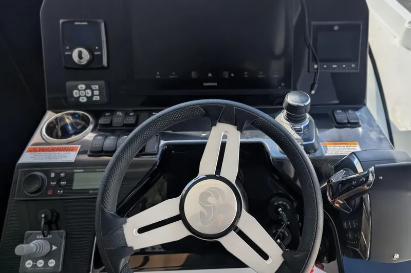 Slide: The Image of 2024 Beneteau Antares 11 helm with modern controls and navigation equipment. - 9