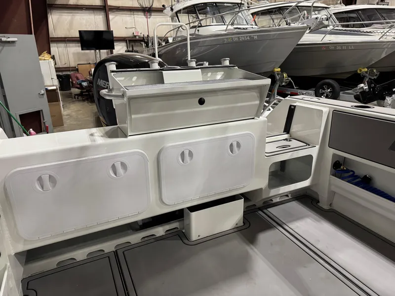 Slide: The Image of 2024 Extreme Boats 616 Game King interior with storage compartments and fishing equipment. - 3