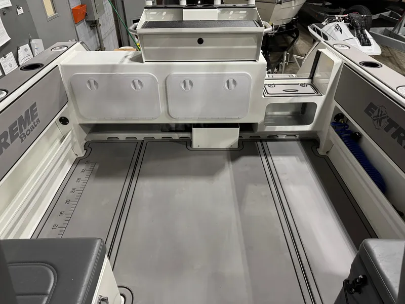 Slide: The Image of 2024 Extreme Boats 616 Game King interior with spacious deck and storage compartments. - 4