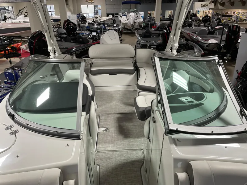Slide: The Image of 2024 Crownline Eclipse E260 XS boat interior with seating and windshield. - 10