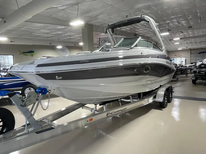 Slide: The Image of 2024 Crownline Eclipse E260 XS boat on trailer in showroom. - 2