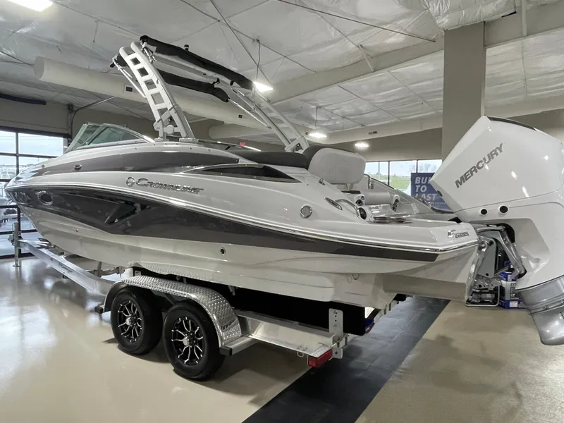 Slide: The Image of 2024 Crownline Eclipse E260 XS boat on display indoors. - 3