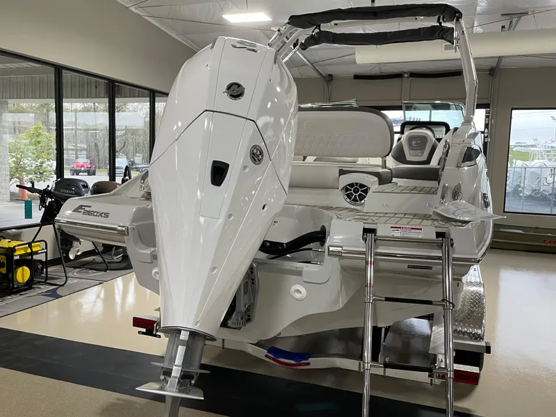 Slide: The Image of 2024 Crownline Eclipse E260 XS boat in showroom, rear view with outboard motor. - 5